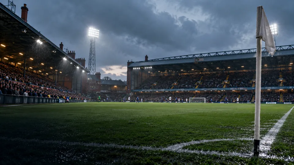 English football ground under floodlights